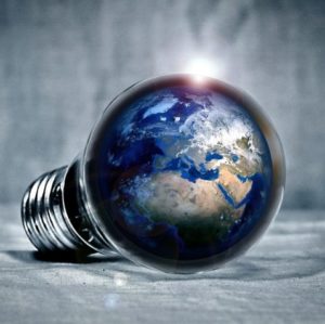 A picture of a lightbulb with the earth inside, representing the illumination of the world through information.